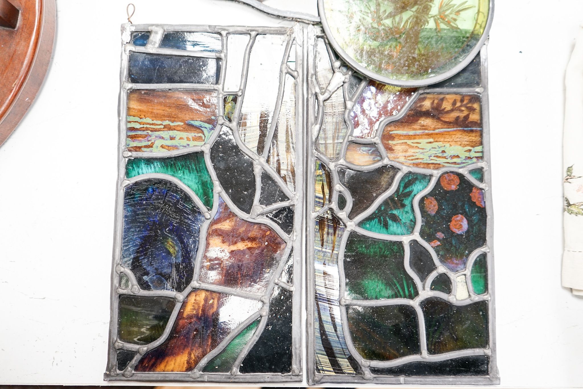 A Victorian stained glass portrait panel, two bird panels and a similar circular bird panel (4)